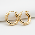 Diamond-cut gold hoop earrings faceted sparkling finish